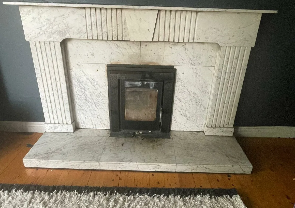 White marble fireplace and insert stove