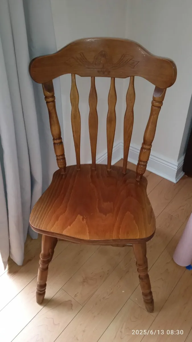 four wooden kitchen chairs