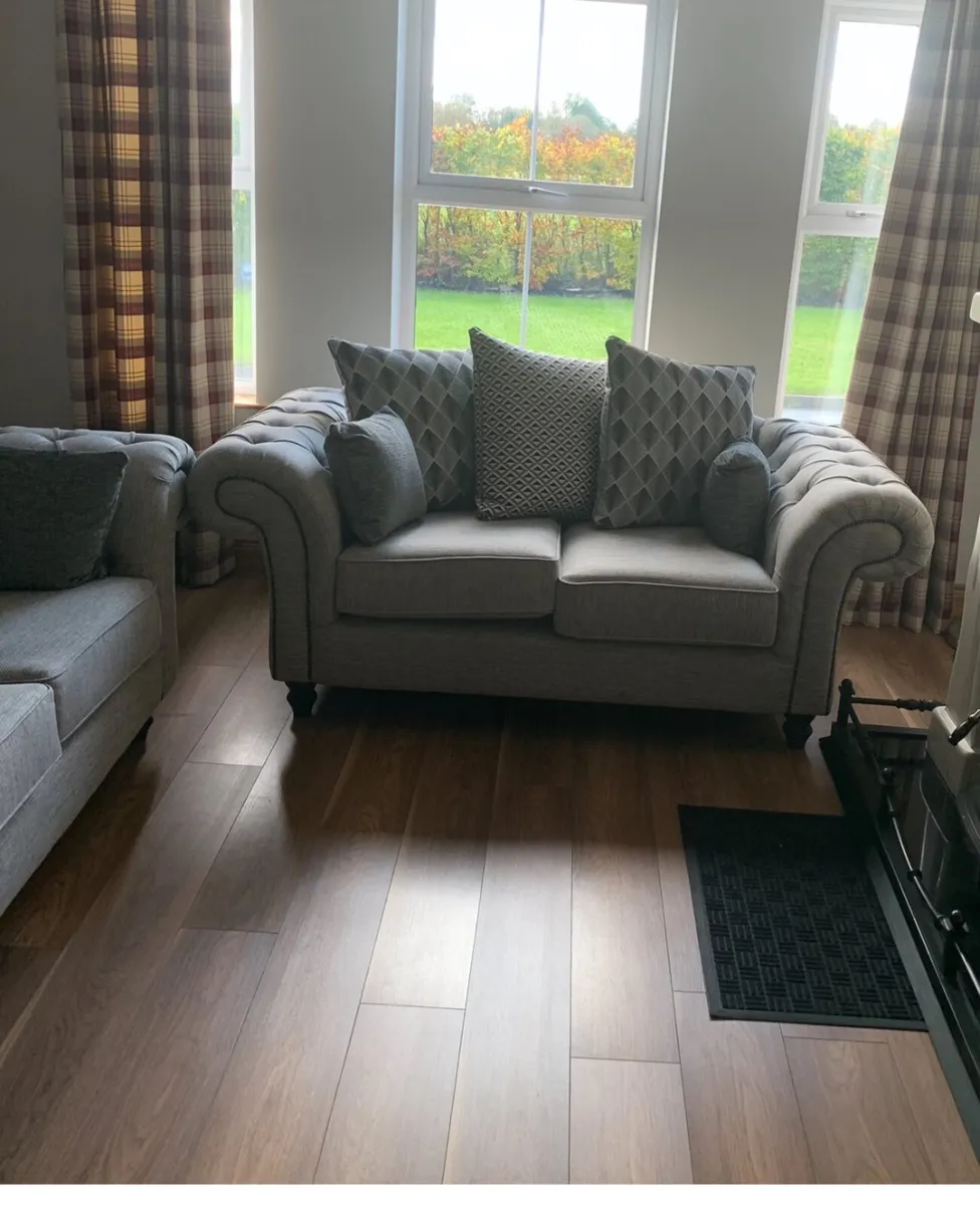 2 seater sofa with scattered cushions