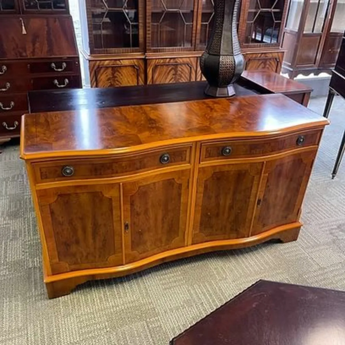 Fabulous yew serpentine front sideboard. Enclosed