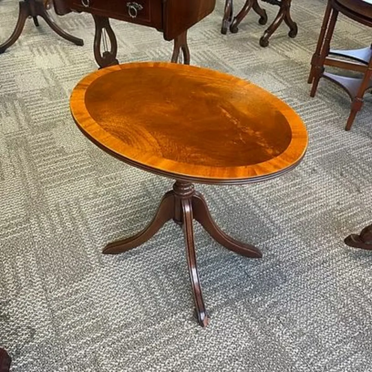 Fabulous mahogany flamed oval tilt top side table.