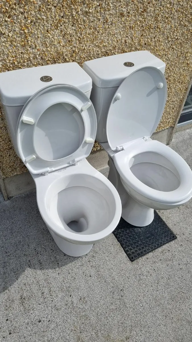 2 toilets with cisterns and seats