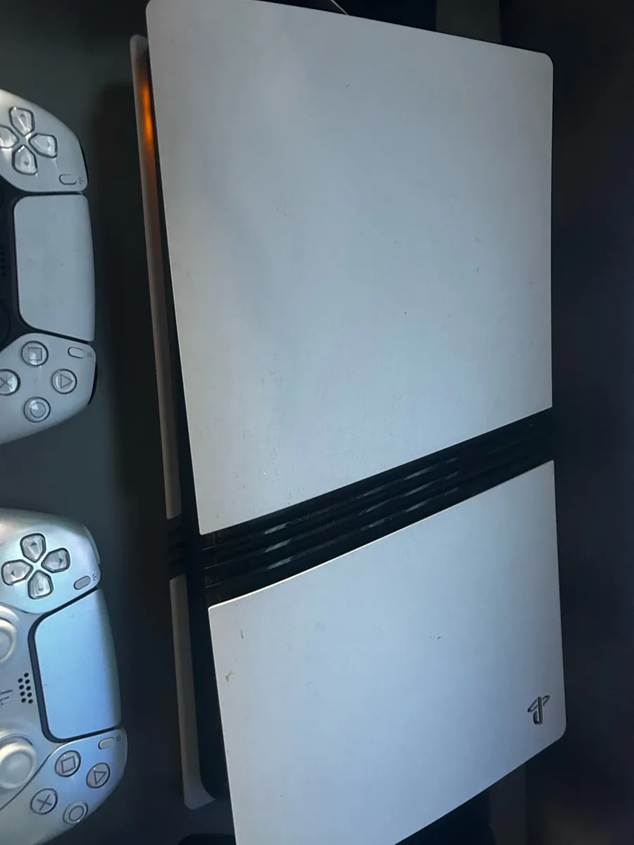 PS5 pro three controllers and a headset - Image 1