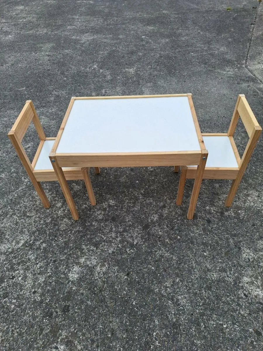 Childrens wooden table and two chairs