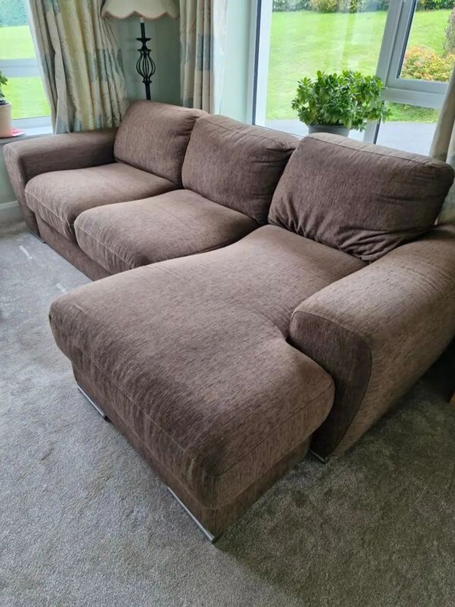 LShaped sofa with pouffe round table four stools - Image 1