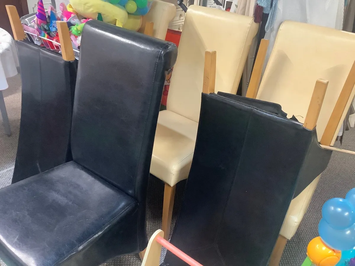 3 cream and 3 black chairs