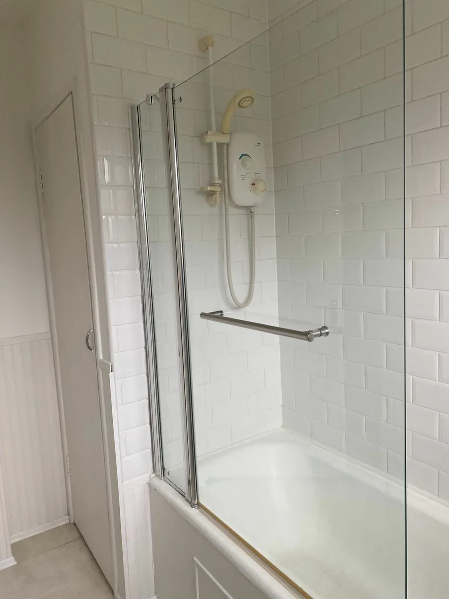 Over bath frameless pivot  shower door