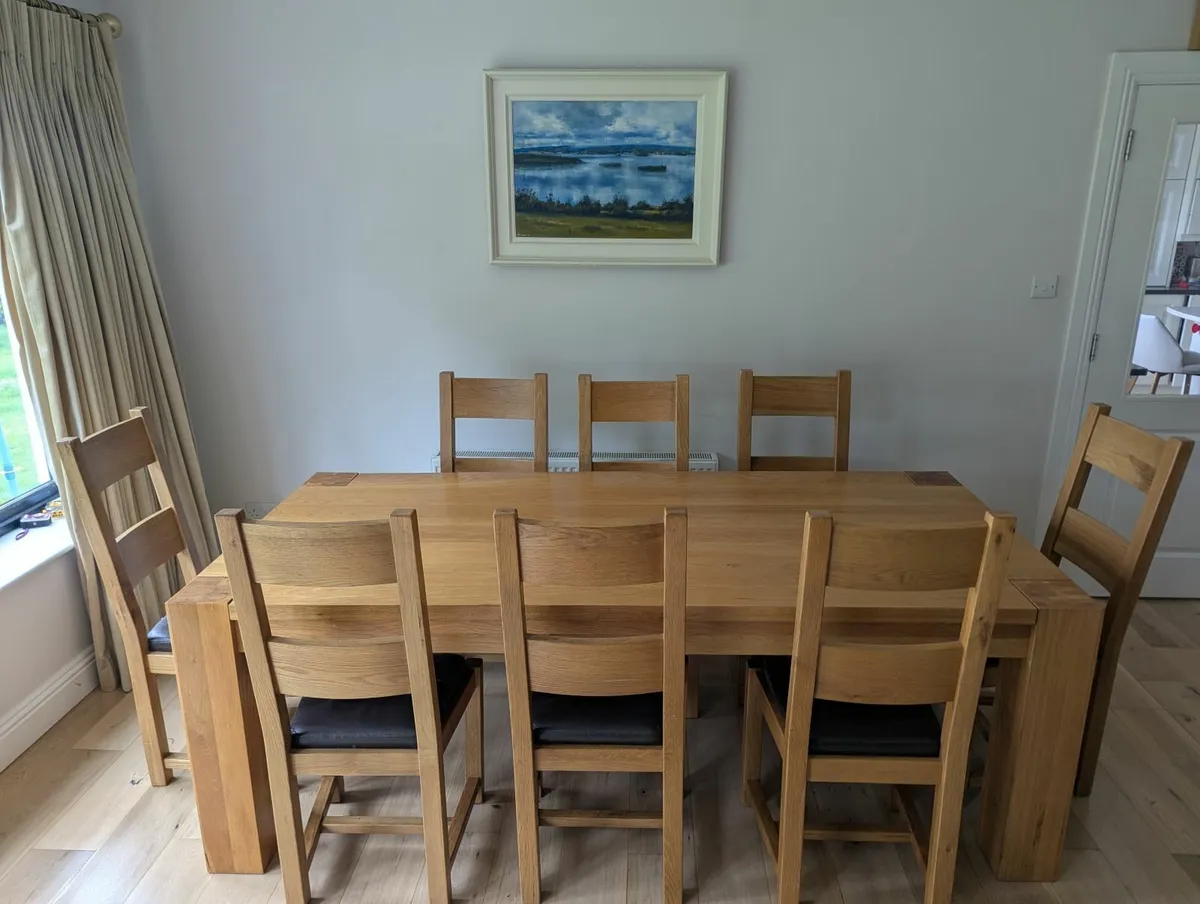 Large solid oak dining table and chairs - Image 1