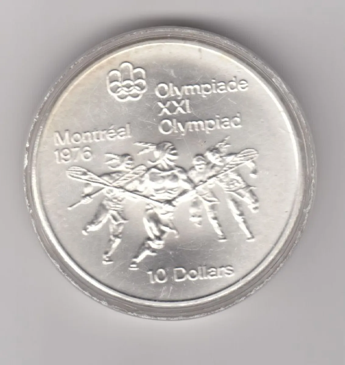 Canada, 1976 Montreal 10 Dollar Olympic Silver Coin, Lacrosse Player 921/2% silver in capsule  note orange colour - Image 1