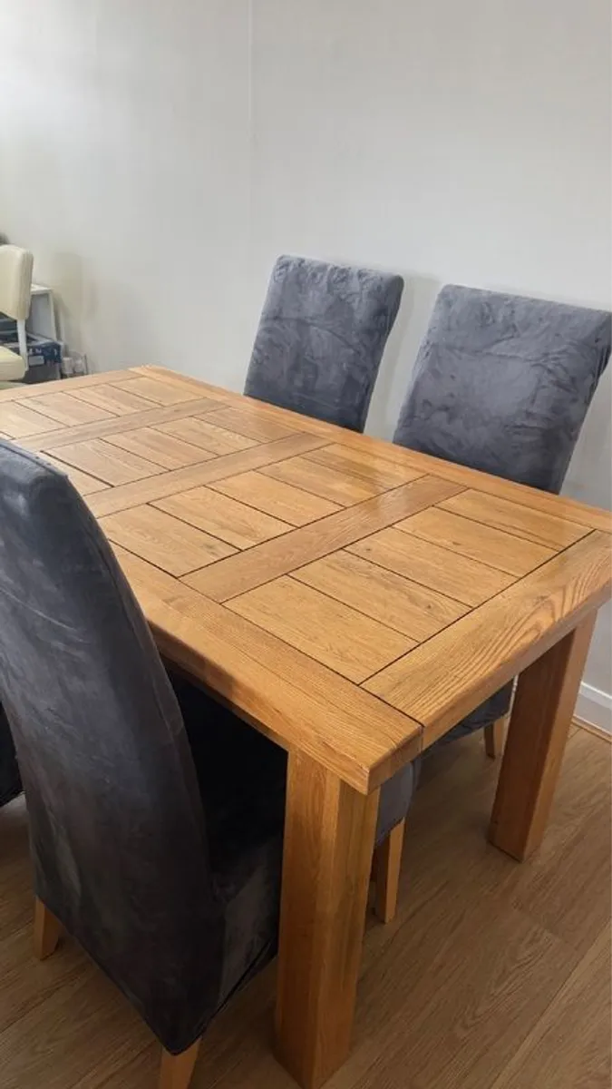 Solid Oak extendable dining room table and four chairs - Image 1