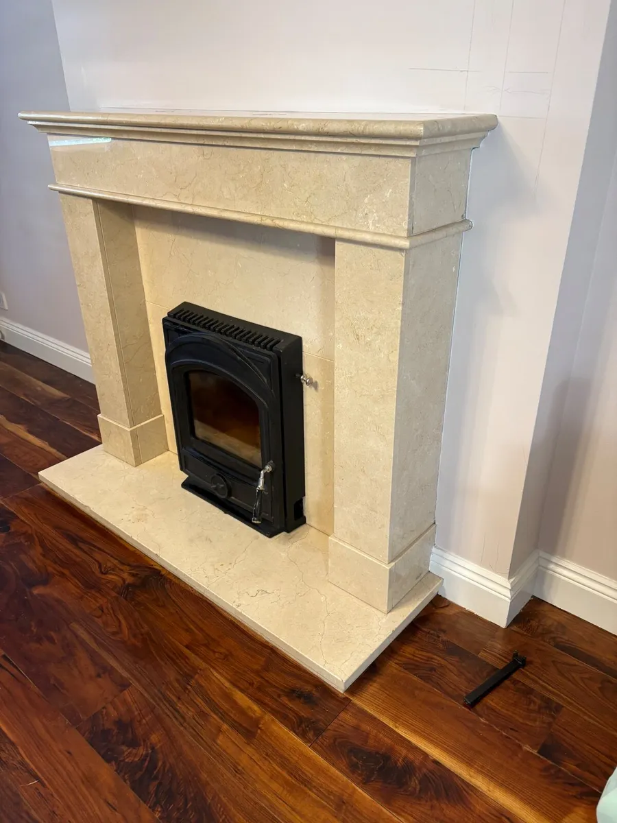 A cream marble fireplace and Stanley insert stove - Image 1