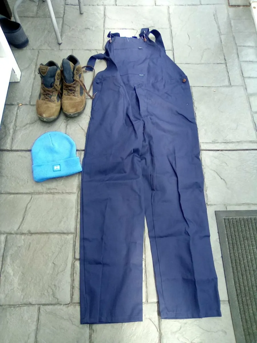 NEW. OVERALLS . A HAT . AND  PAIR OF HIKING BOOTS - Image 1