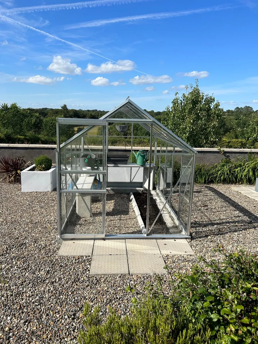 Glass greenhouse for sale with interior shelving - Image 1