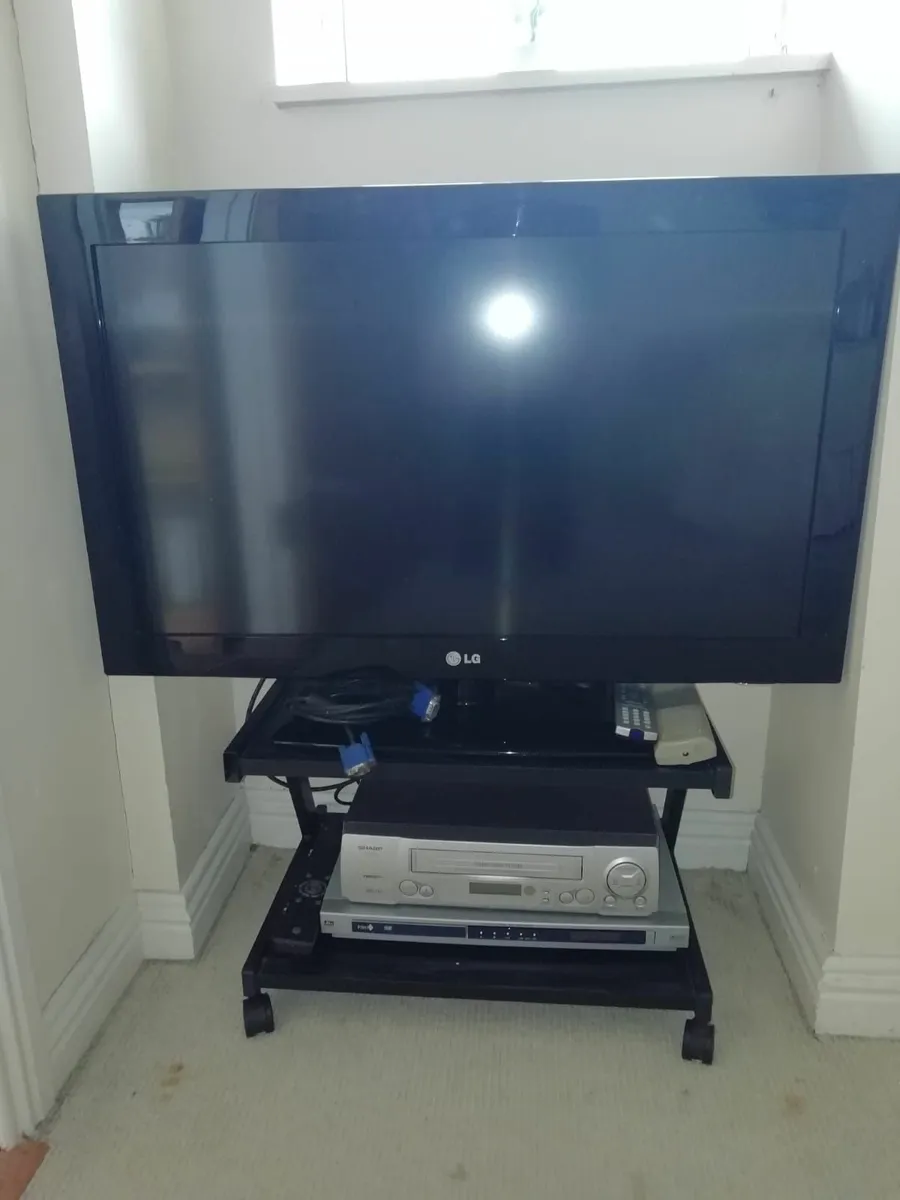 LG TV and Sharp DVD player combo on table - Image 1