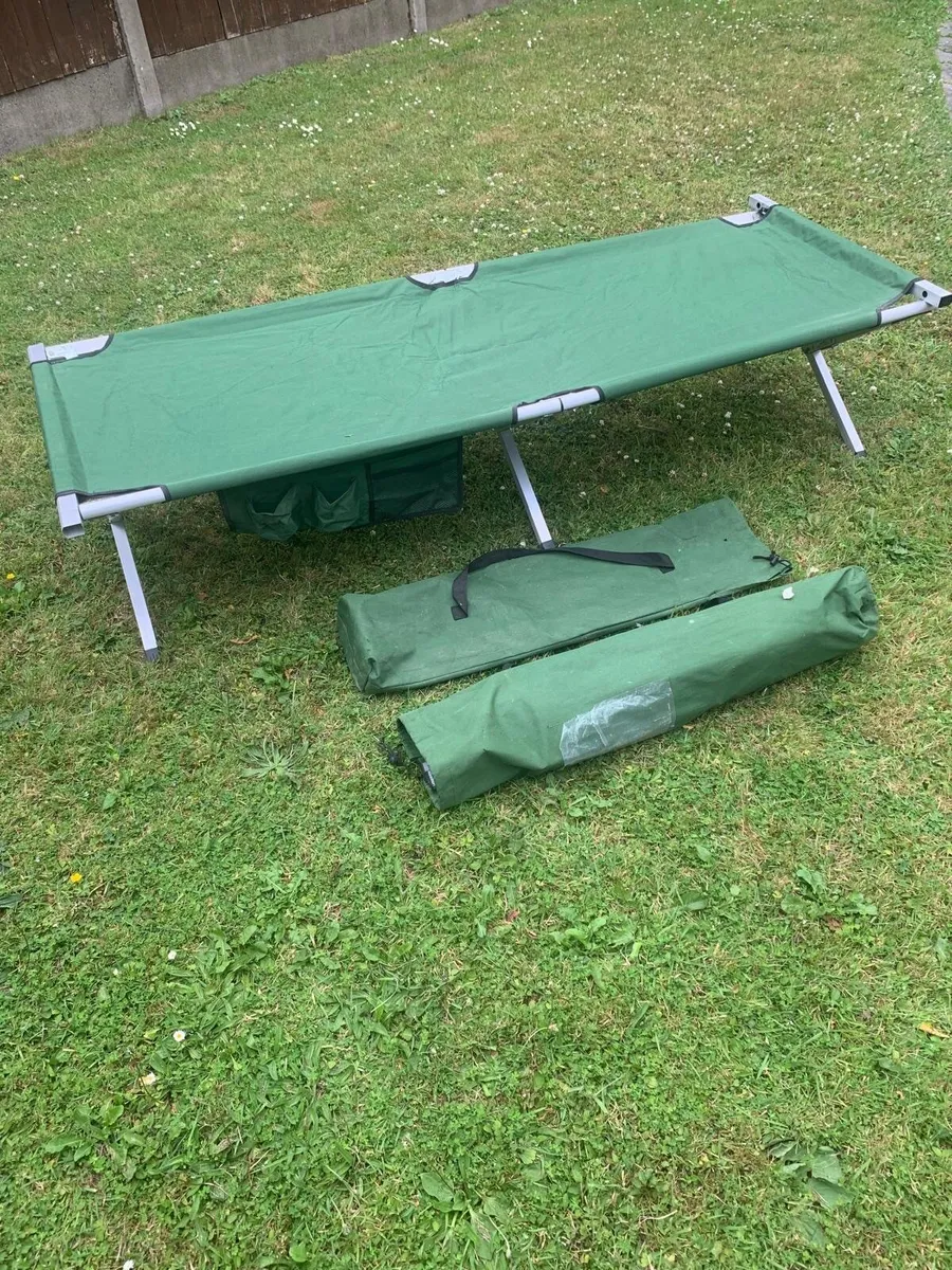 Two green camping beds