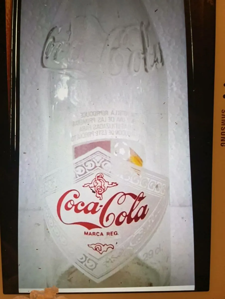 VINTAGE COLA COLA BOTTLE WITH THE EMBOSSED LOGO..