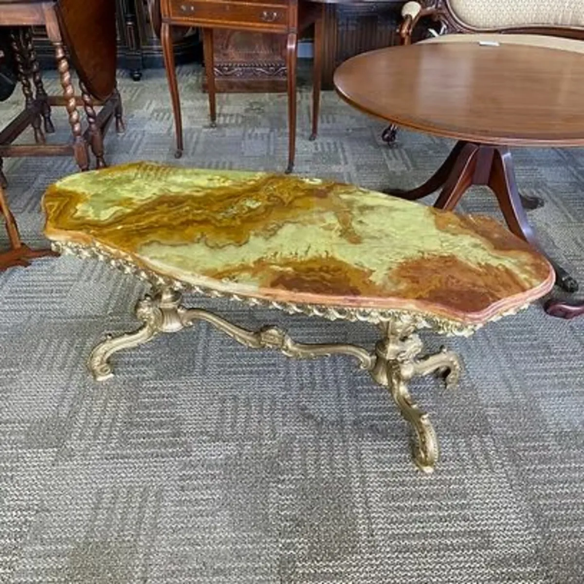 Fabulous shaped onyx coffee table. Brass based, ve