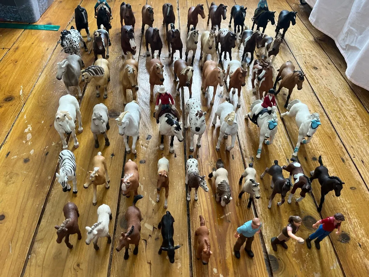 Collection of toy horses with riders