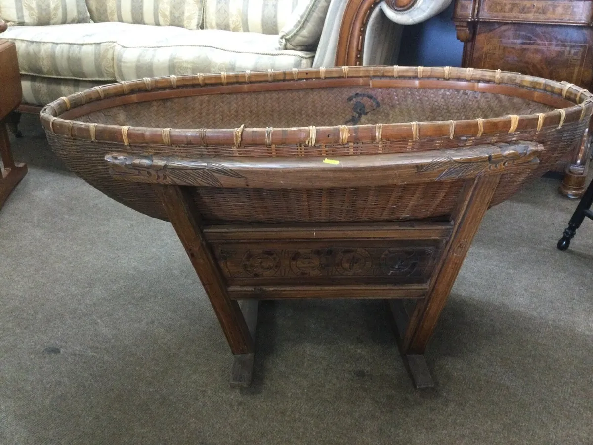 An antique Chinese babies basket