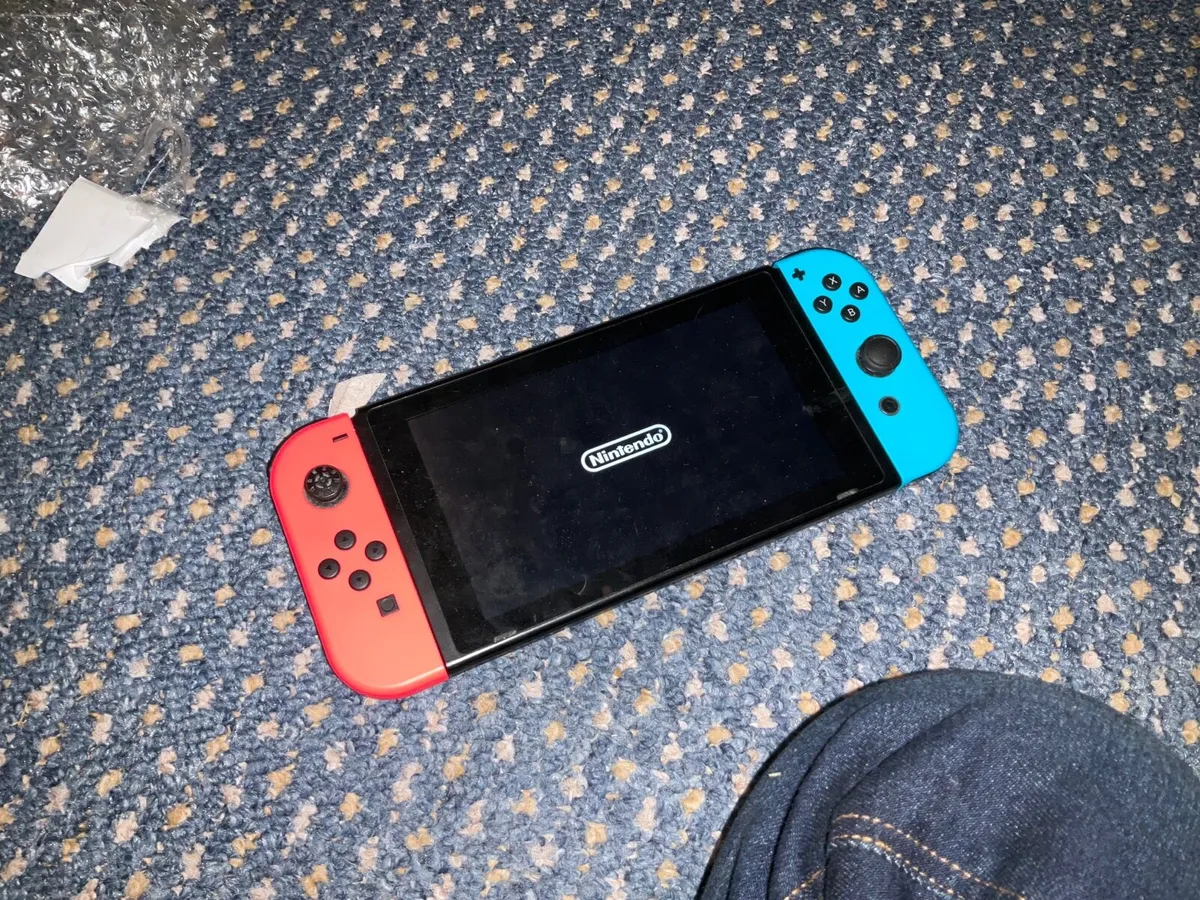 Nintendo Switch with Joy Con straps and case - Image 2