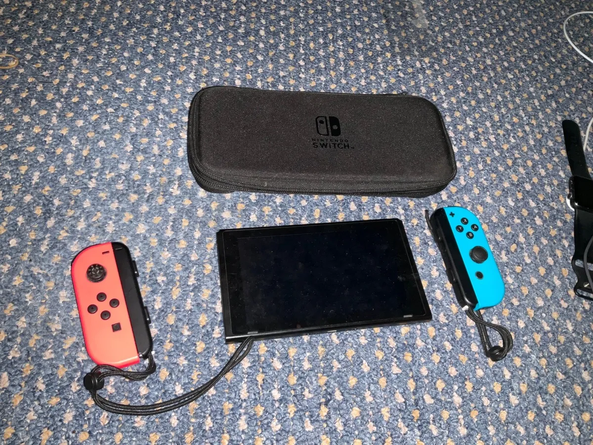 Nintendo Switch with Joy Con straps and case - Image 1