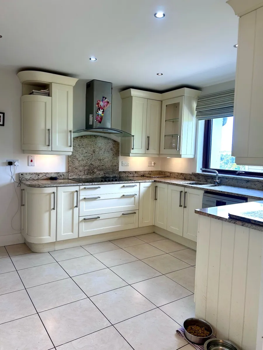 Kitchen with quartz countertop and appliances. - Image 3