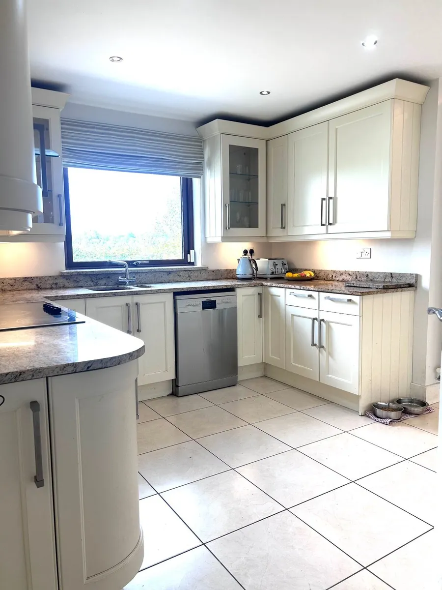 Kitchen with quartz countertop and appliances. - Image 2