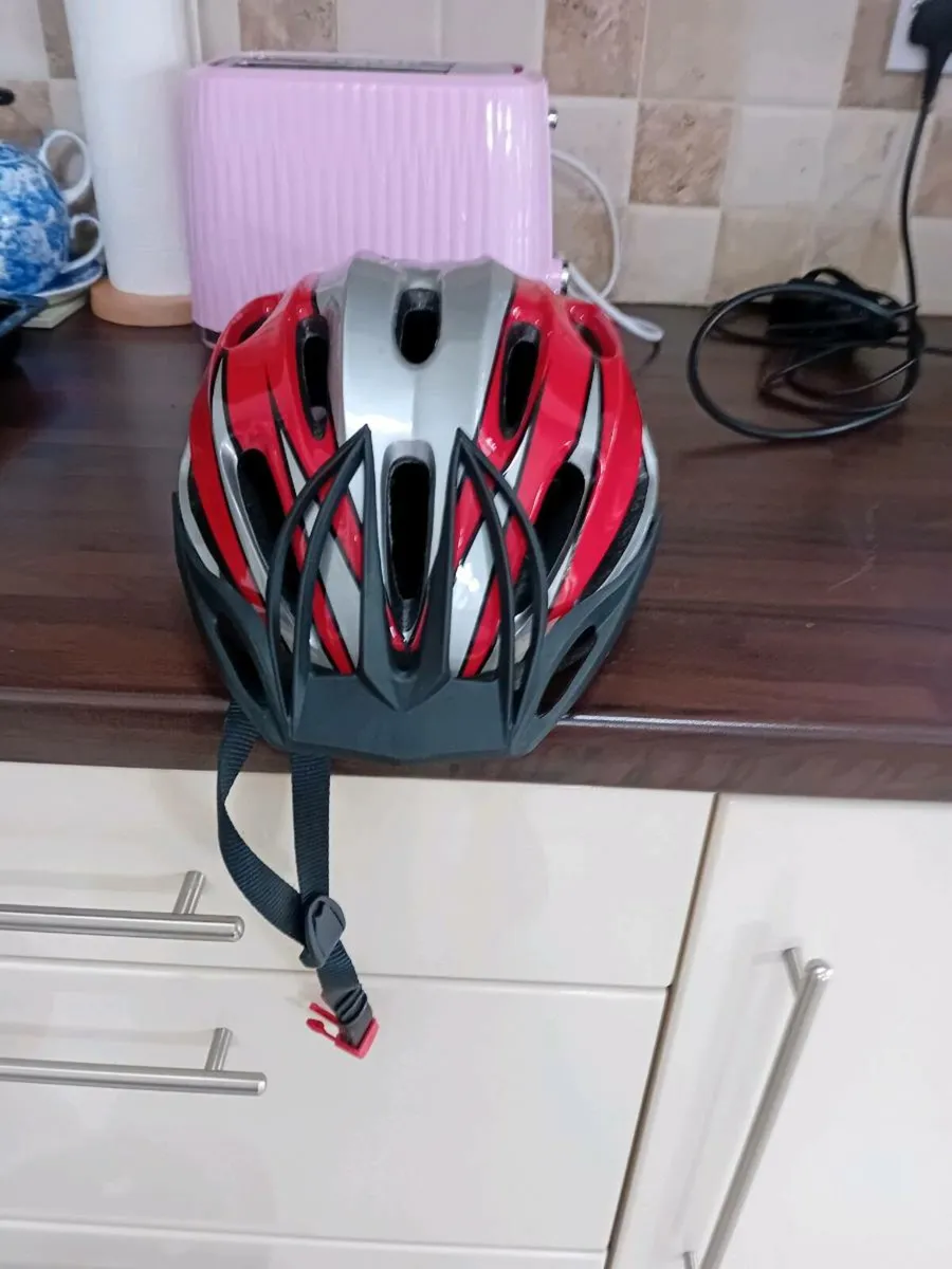 2 ADULT BIKE HELMETS AS NEW - Image 1