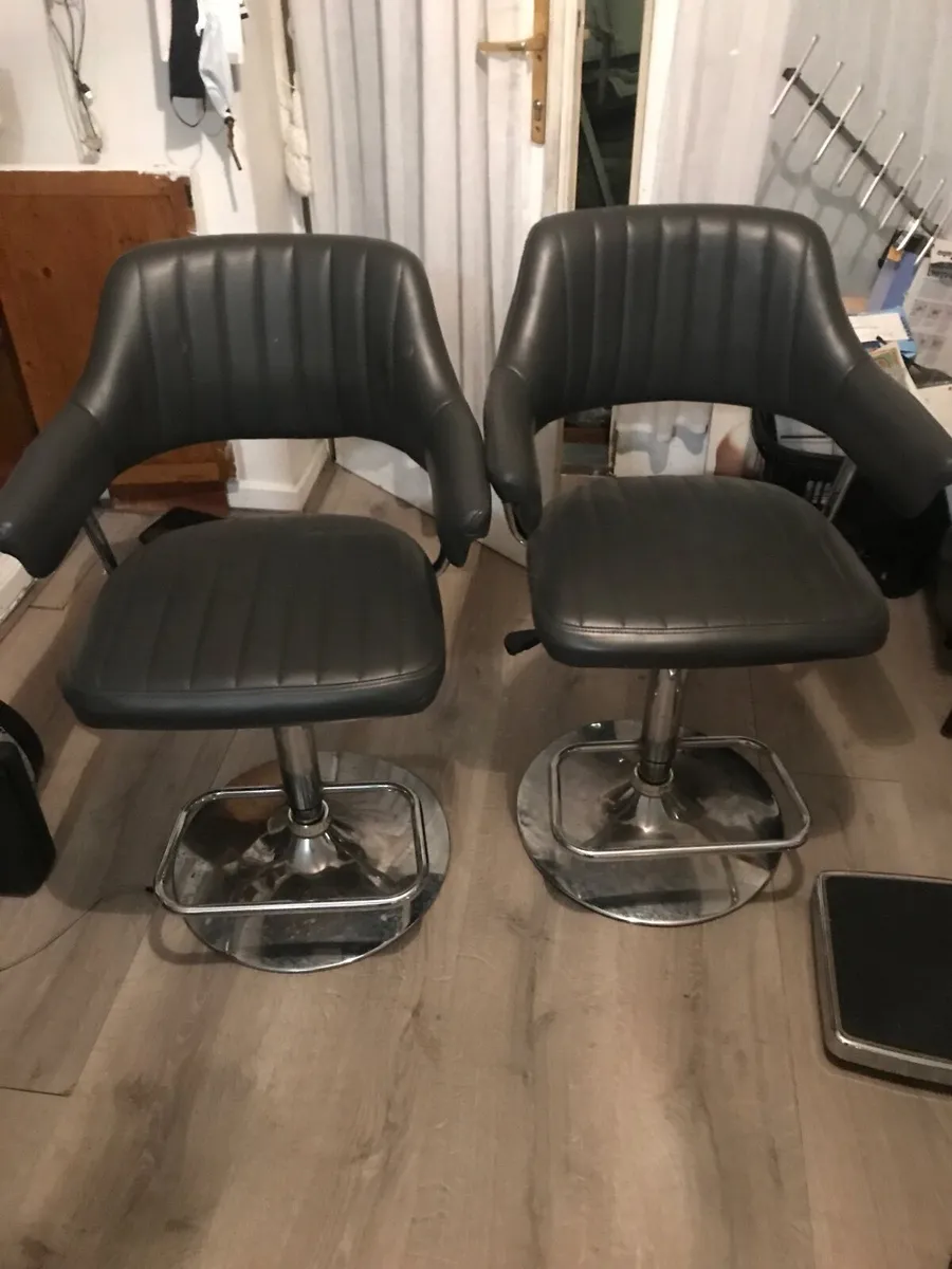 2 grey kitchen swivel stools