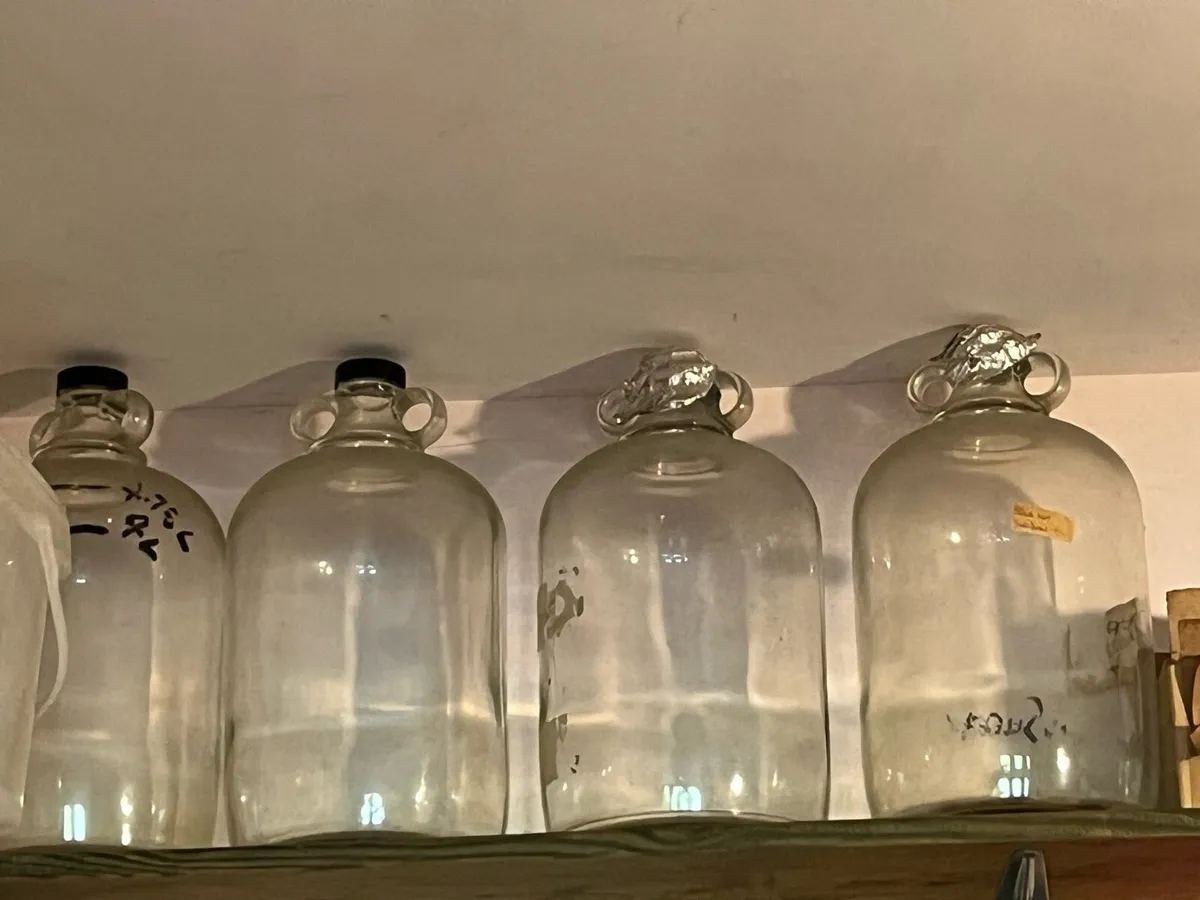 Four glass demijohns