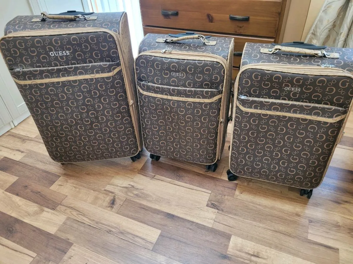 3  brand new designer guess suitcases - Image 1