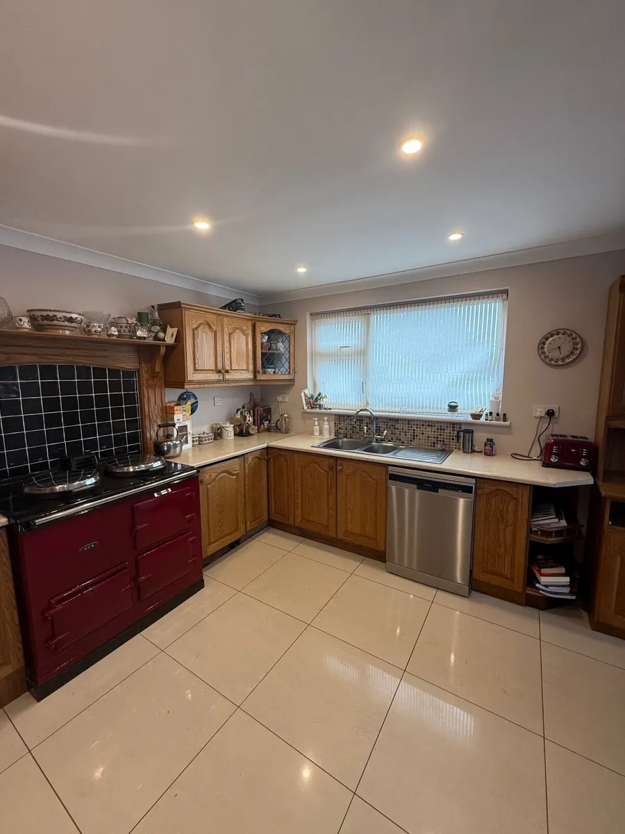 Oak kitchen with taps and integrated fridge - Image 1