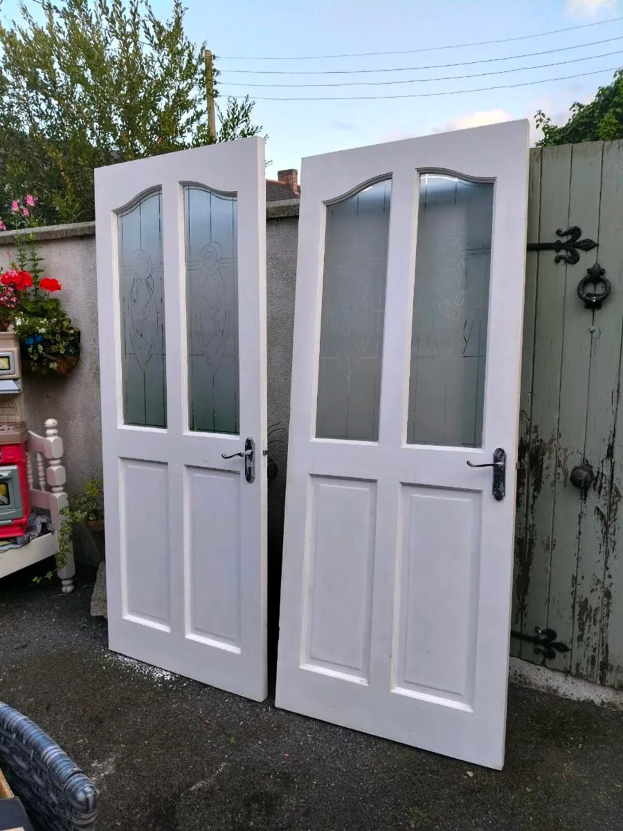 2 white solid timber doors with 2 glass panels. - Image 1