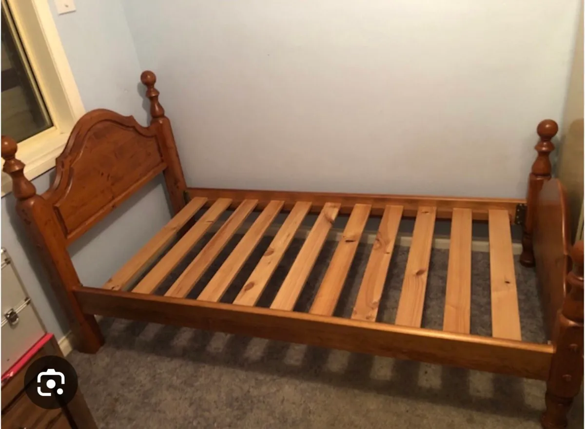 2 wooden single beds with mattresses