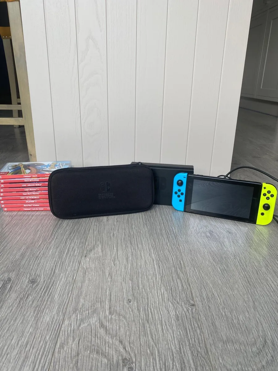 Nintendo switch, charger, stand, case and 9 games - Image 1