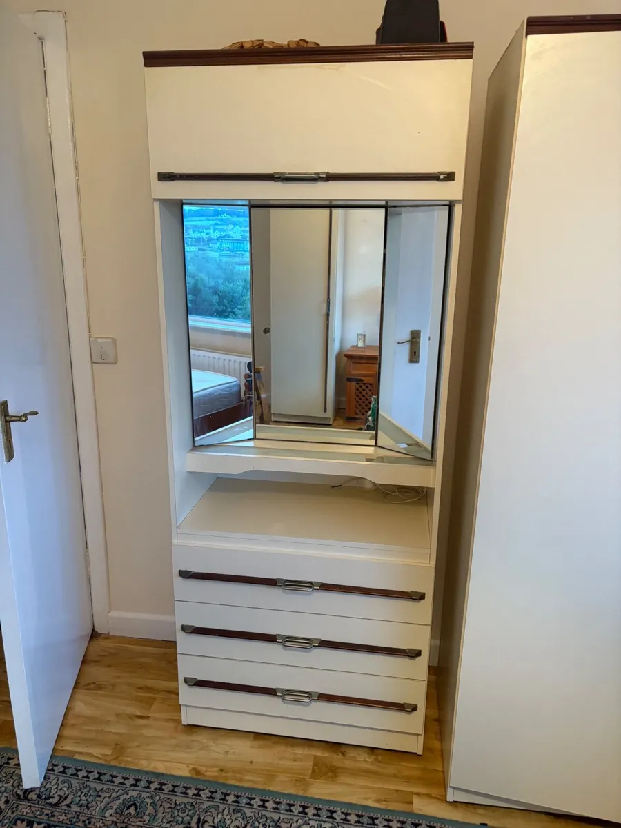 Vanity unit with drawers and mirror.