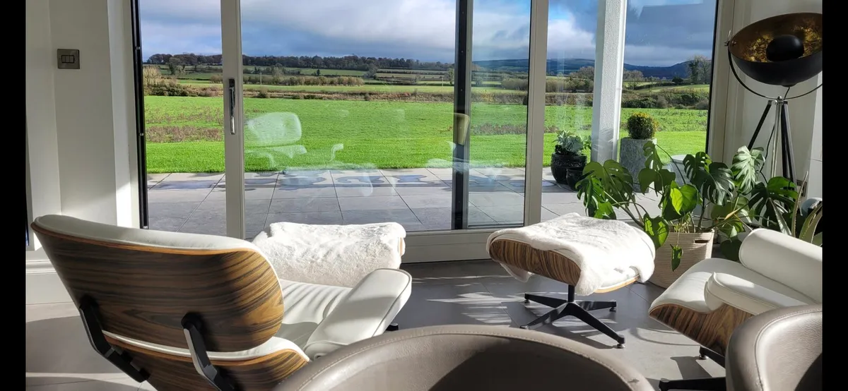 Eames inspired lounge chairs with ottomans. - Image 1
