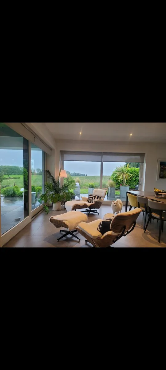 Eames inspired lounge chairs with ottomans. - Image 3