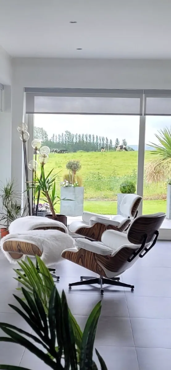 Eames inspired lounge chairs with ottomans. - Image 2