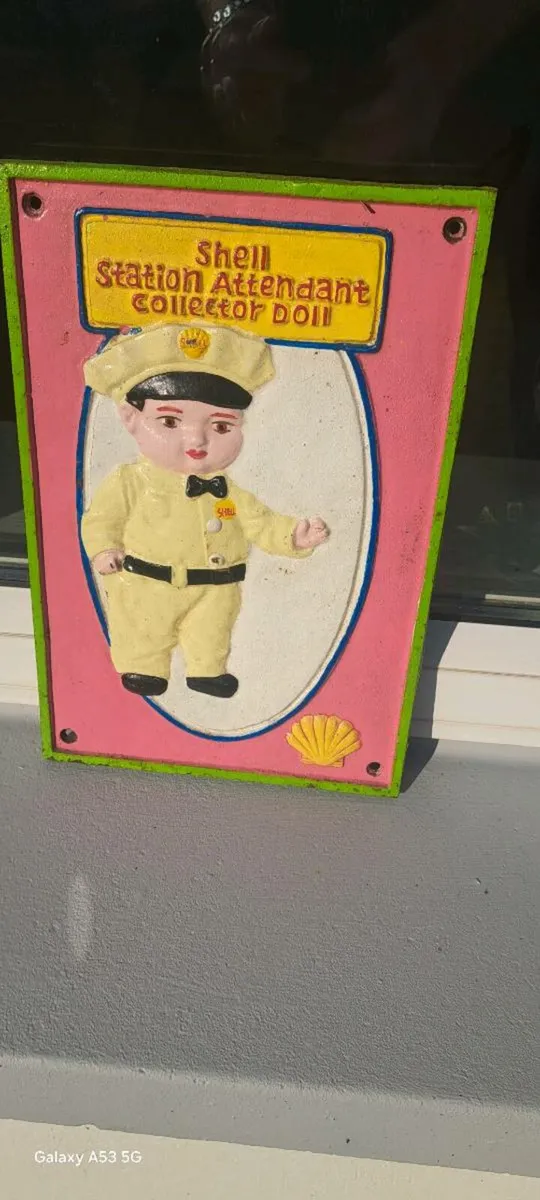 Shell man cast iron sign