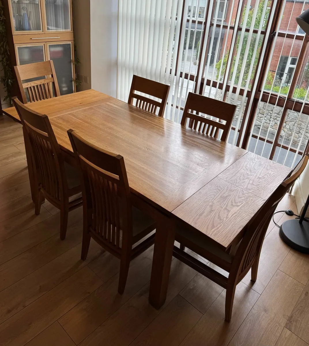 Extendable solid oak dining table with six chairs - Image 1