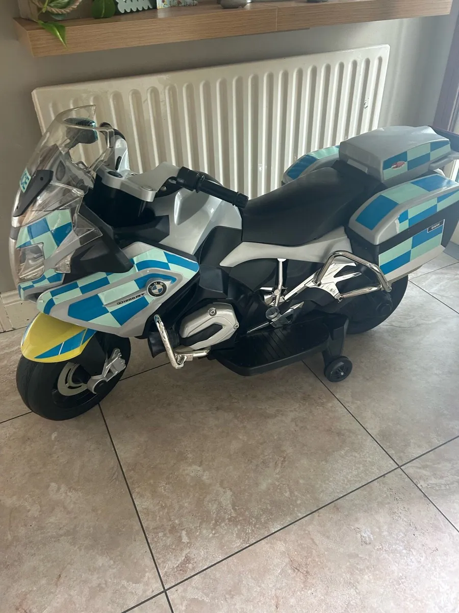 Boys ride on police  bike