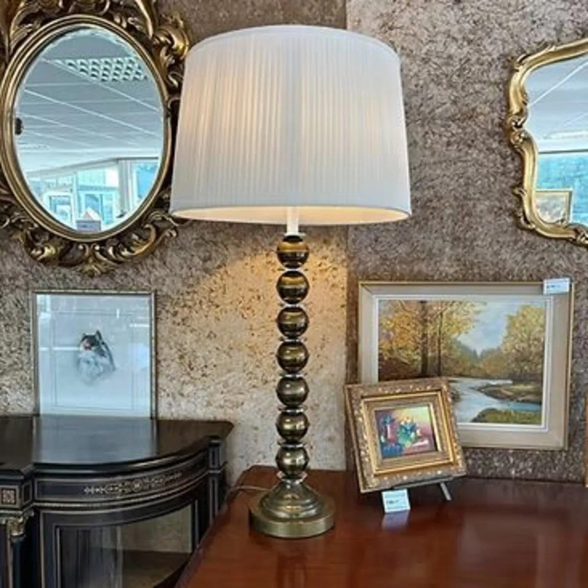 A contemporary table lamp with a pleated fabric la