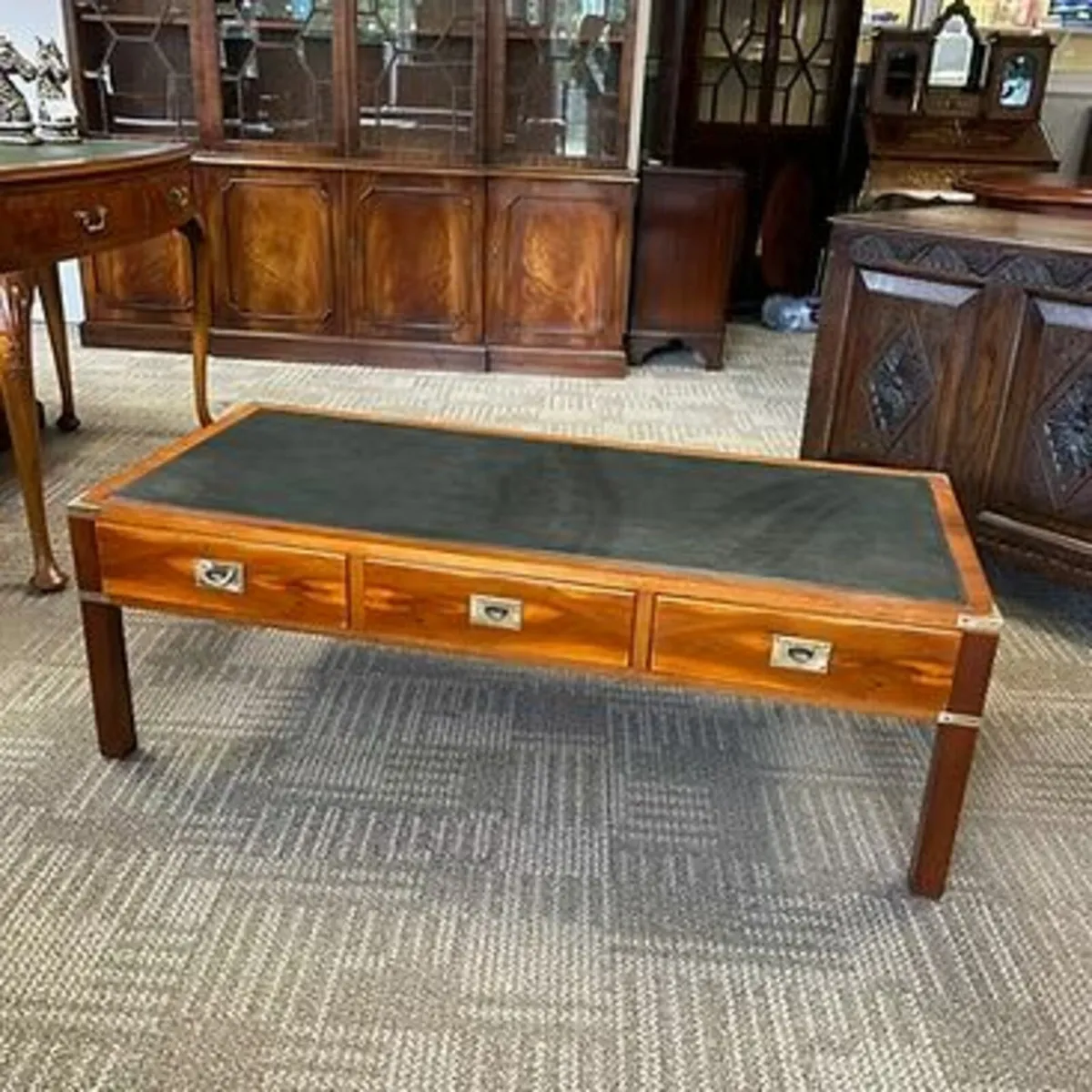 Fabulous green leather top campaign coffee table.