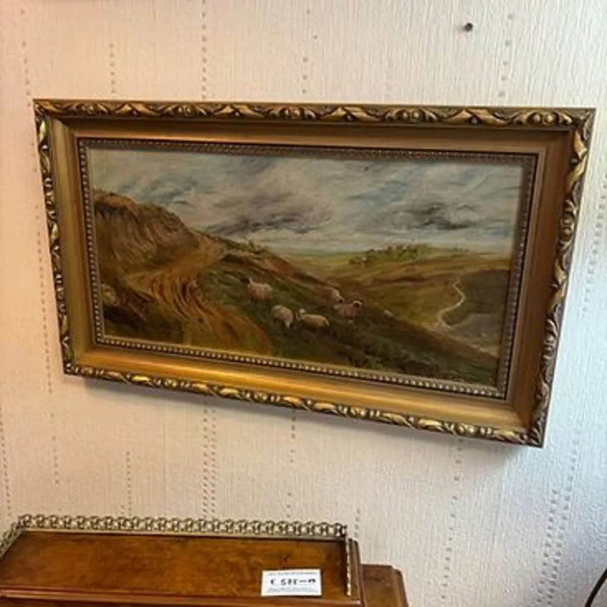 Oil on canvas depicting sheep in the country side.