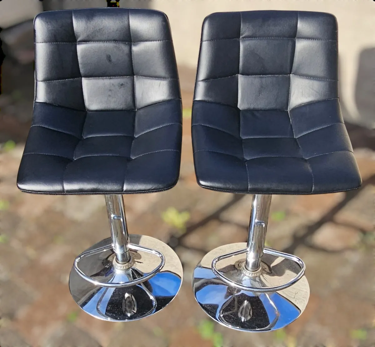 Black raised kitchen chairs with a chrome base - Image 1