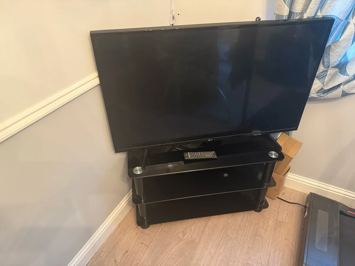 42’ Flatscreen TV + Cabinet - Image 1