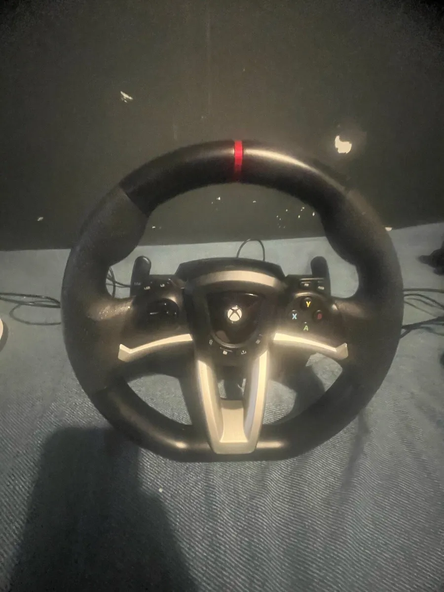 A Xbox steering wheel and pedals - Image 1
