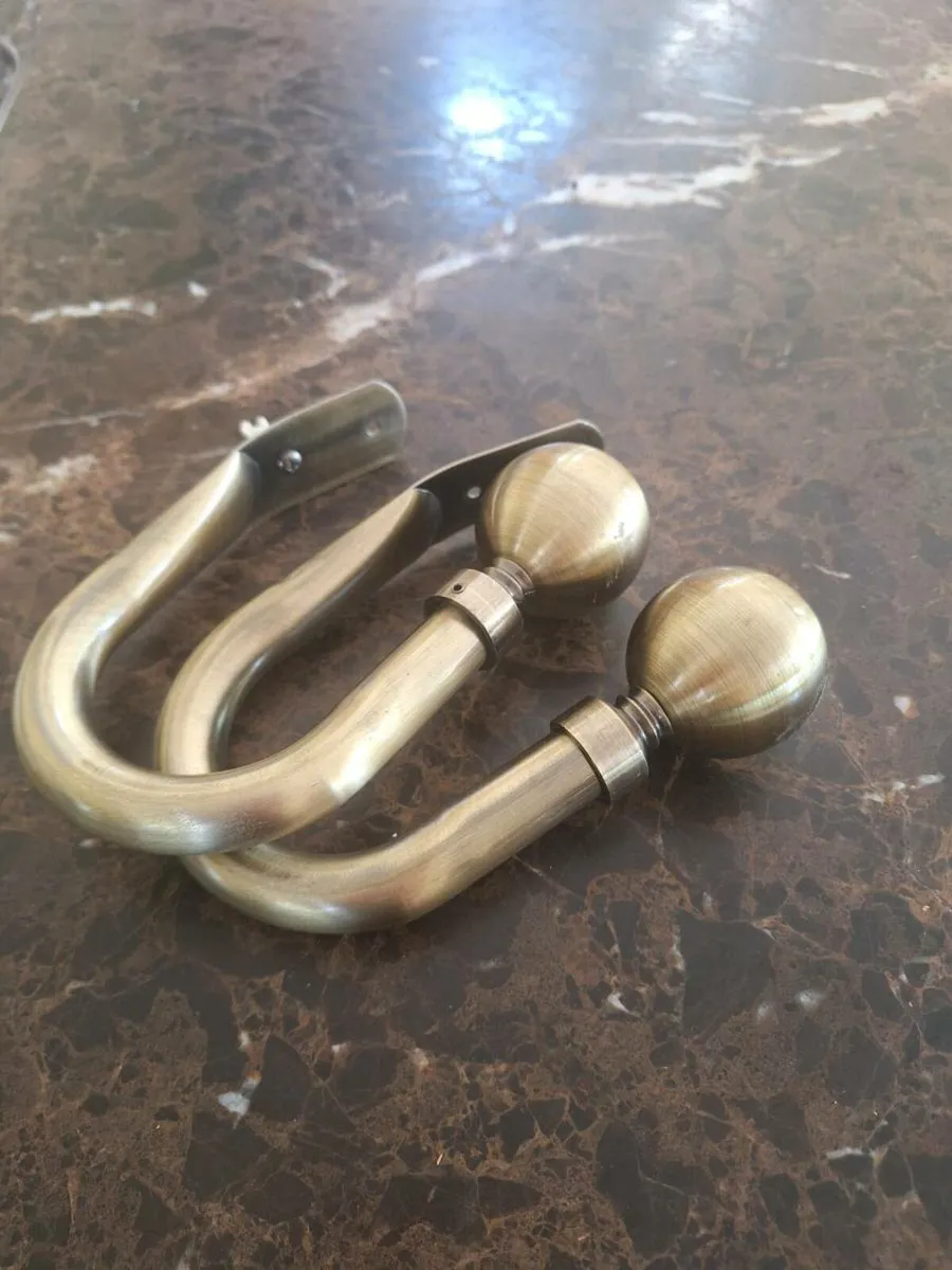 Brass curtain tie back holds