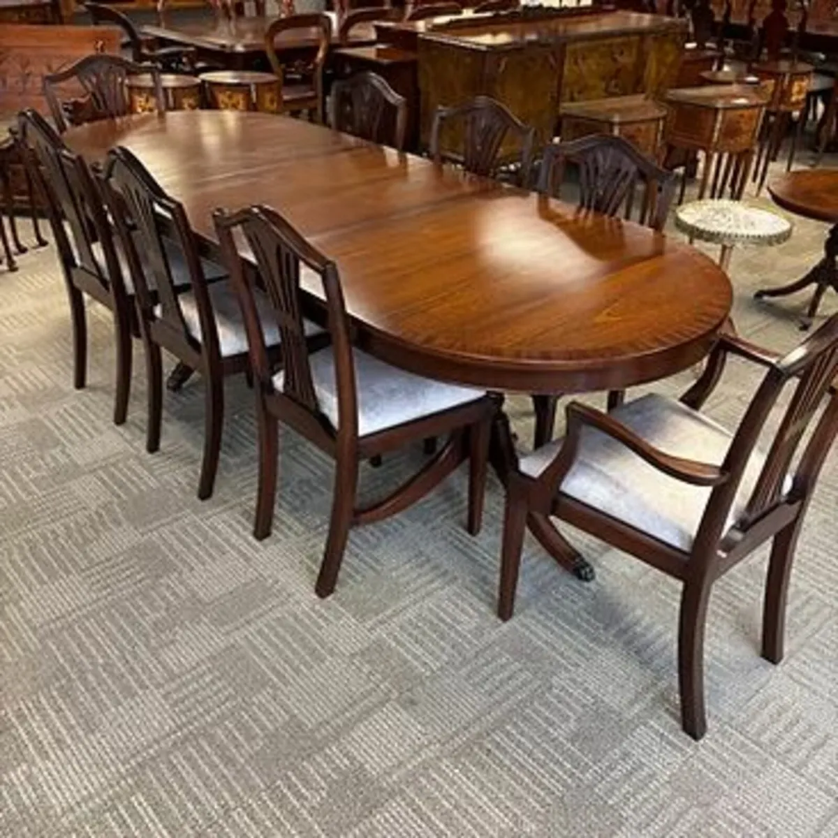Mahogany oval shaped dining table with 8 chairs